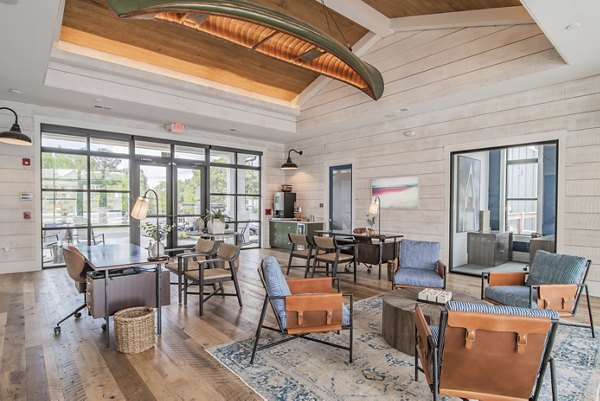 Modern community clubhouse at The Heron at River Island Apartments featuring cozy lounge seating and elegant design for social gatherings