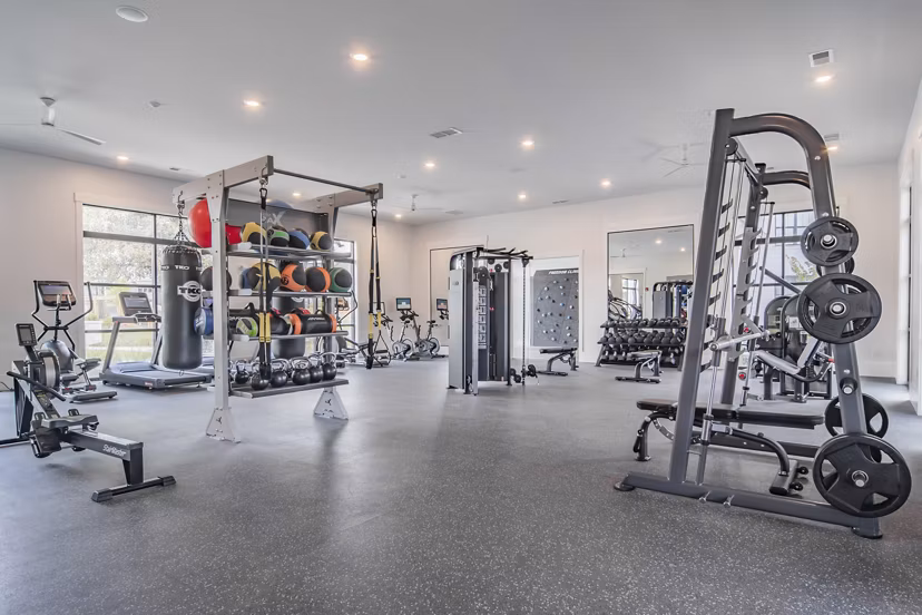 State-of-the-art fitness center at The Heron at River Island Apartments with modern equipment and spacious workout area for residents