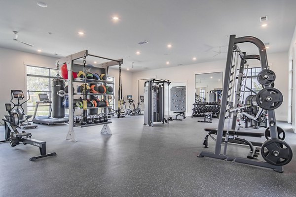 State-of-the-art fitness center at The Heron at River Island Apartments with modern equipment and spacious workout area for residents