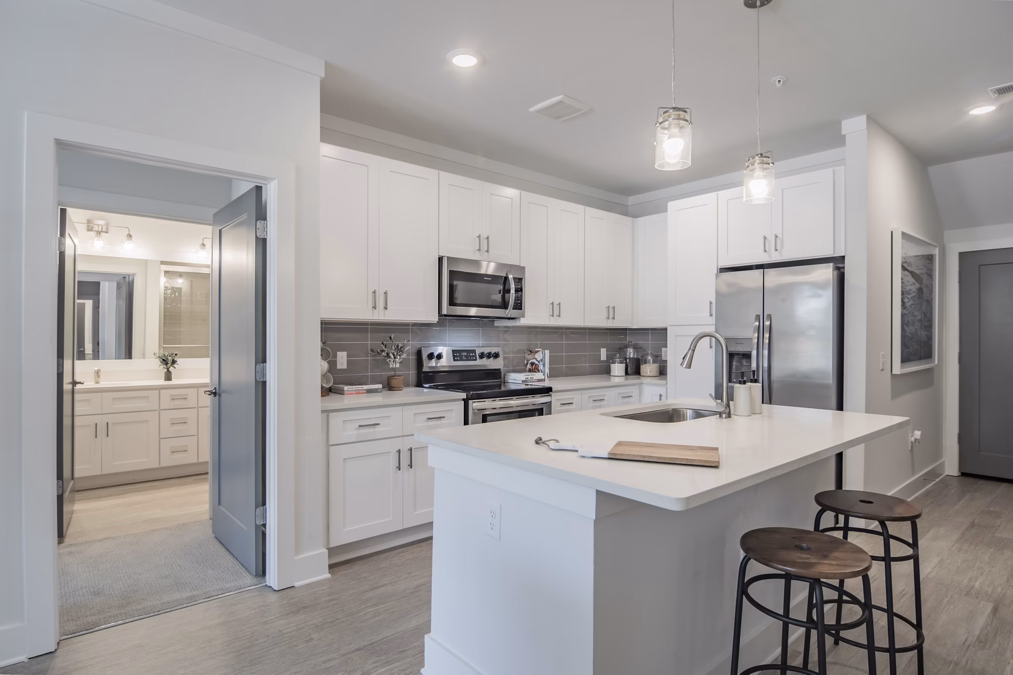 Modern kitchen with stainless steel appliances and island at The Heron at River Island Apartments