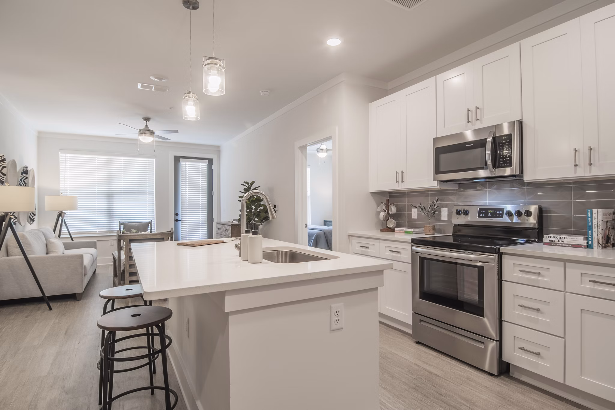 Modern kitchen with stainless steel appliances in The Heron at River Island apartments