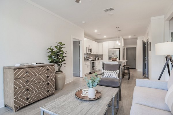 Living room featuring modern design with large windows at The Heron at River Island Apartments