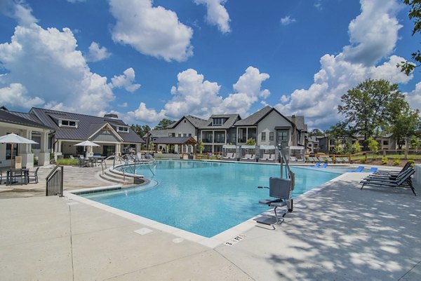 â€œResort-style pool at The Heron at River Island Apartments offering relaxation and luxury in scenic surroundingsâ€
