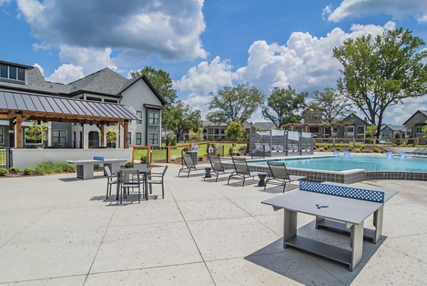 Courtyard featuring lush landscaping and seating areas at The Heron at River Island Apartments