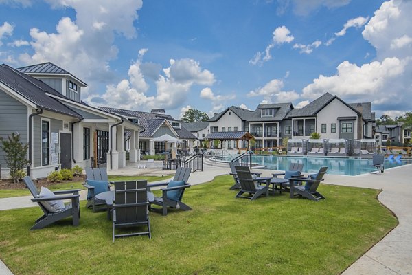 The Heron at River Island: Serene courtyard with lush landscaping and seating areas, perfect for relaxation in luxury apartments