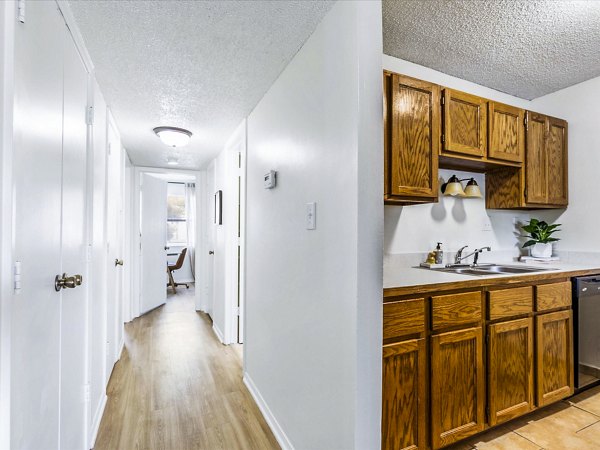 Modern kitchen with sleek cabinetry and stainless steel appliances in Parc at 21st & Rock Apartments
