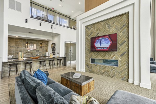 Game room with billiards and lounge seating at Liberty Bay Club Apartments