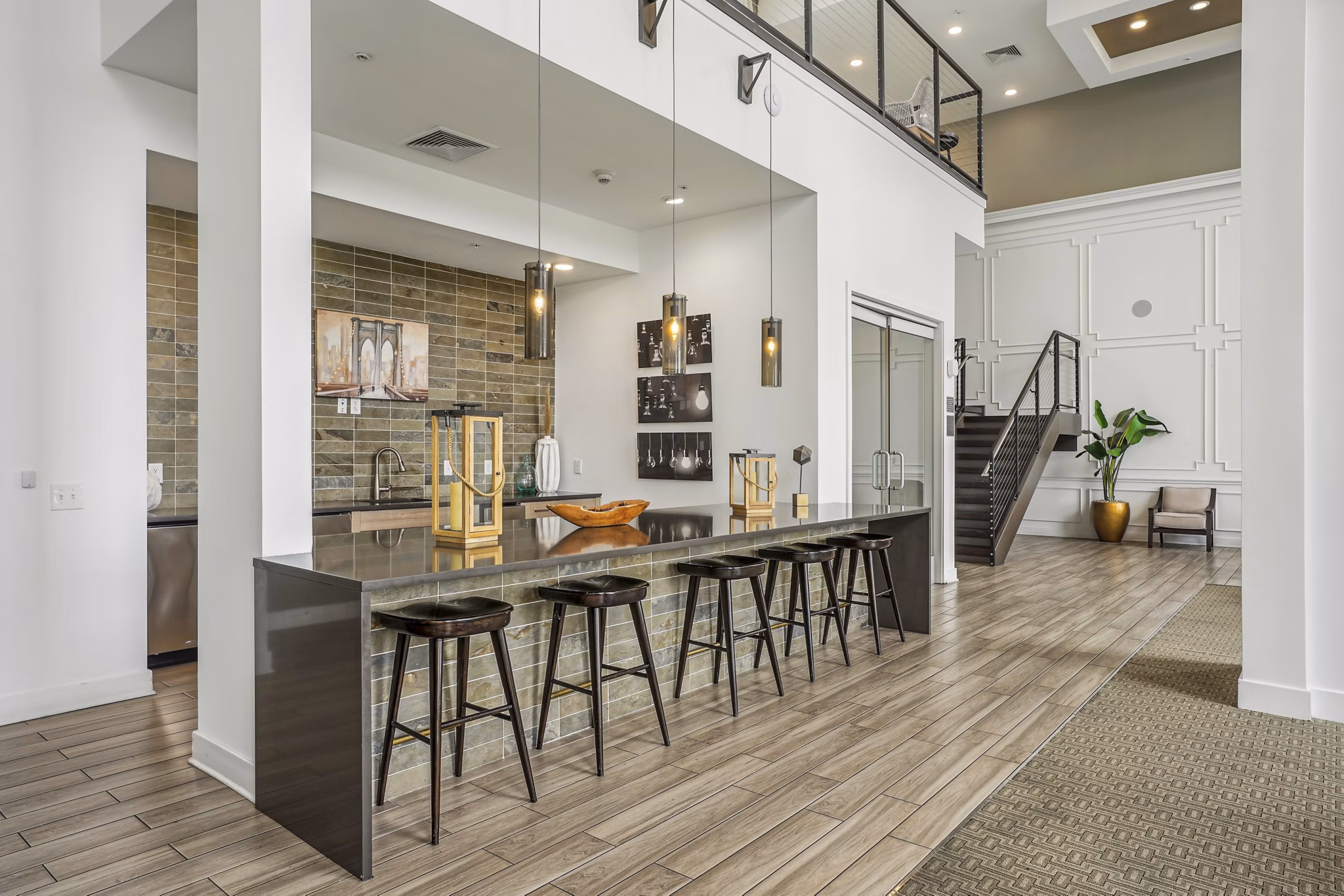Clubhouse with modern decor at Liberty Bay Club Apartments featuring comfortable seating and large windows for natural light