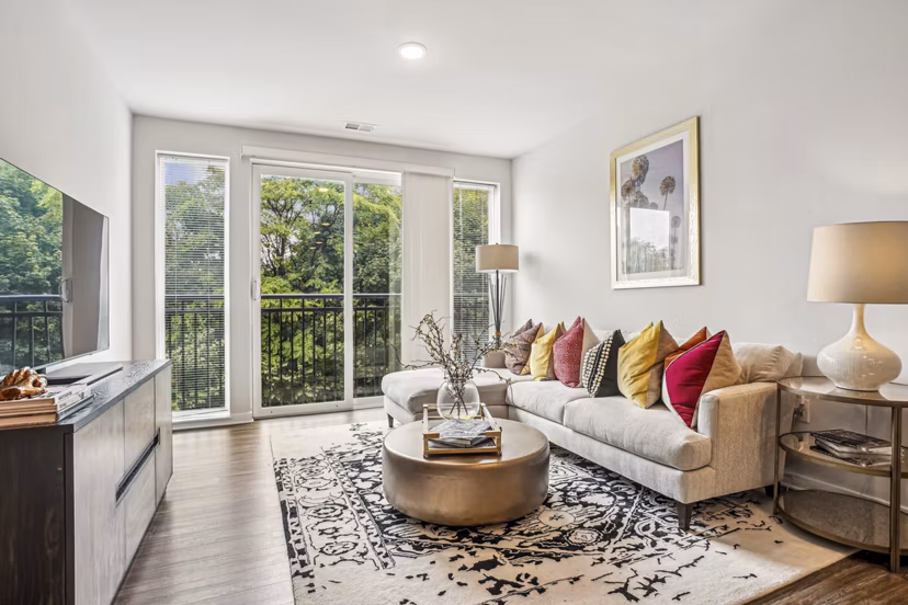 Stylish living room with contemporary decor in Liberty Bay Club Apartments, offering a luxurious Greystar lifestyle