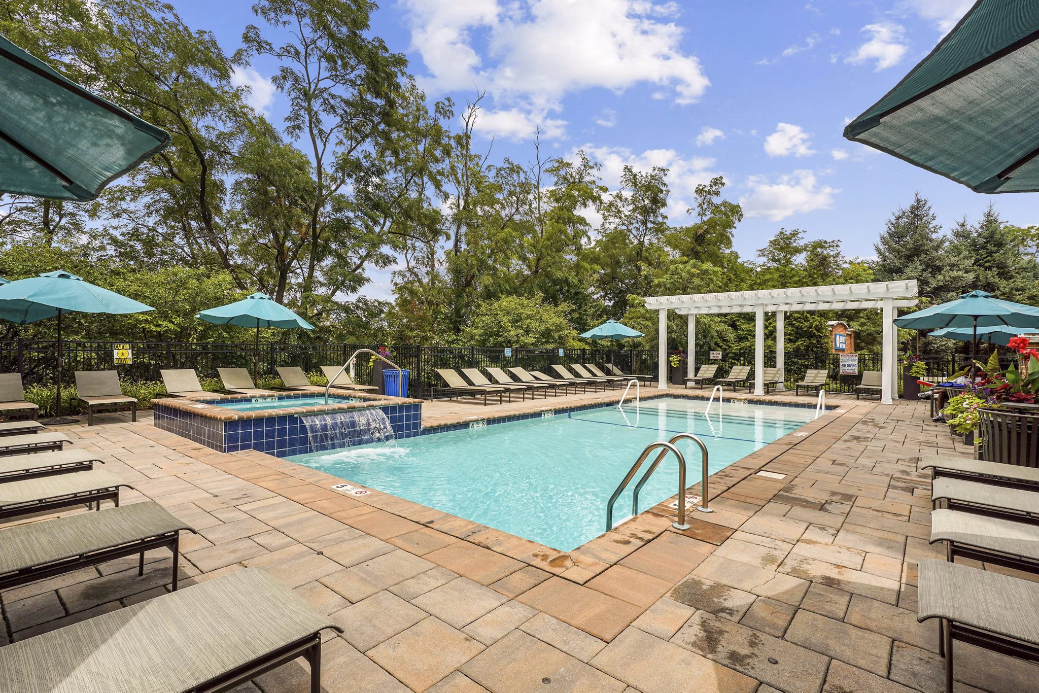 Sparkling outdoor pool at Liberty Bay Club Apartments, perfect for relaxation and recreation in this luxury community