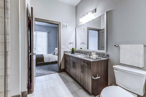 Bathroom with modern fixtures and marble countertops at Shoreview Flats Apartments, Greystar luxury living
