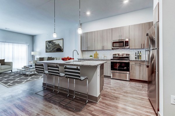 Modern kitchen with stainless steel appliances at Shoreview Flats Apartments