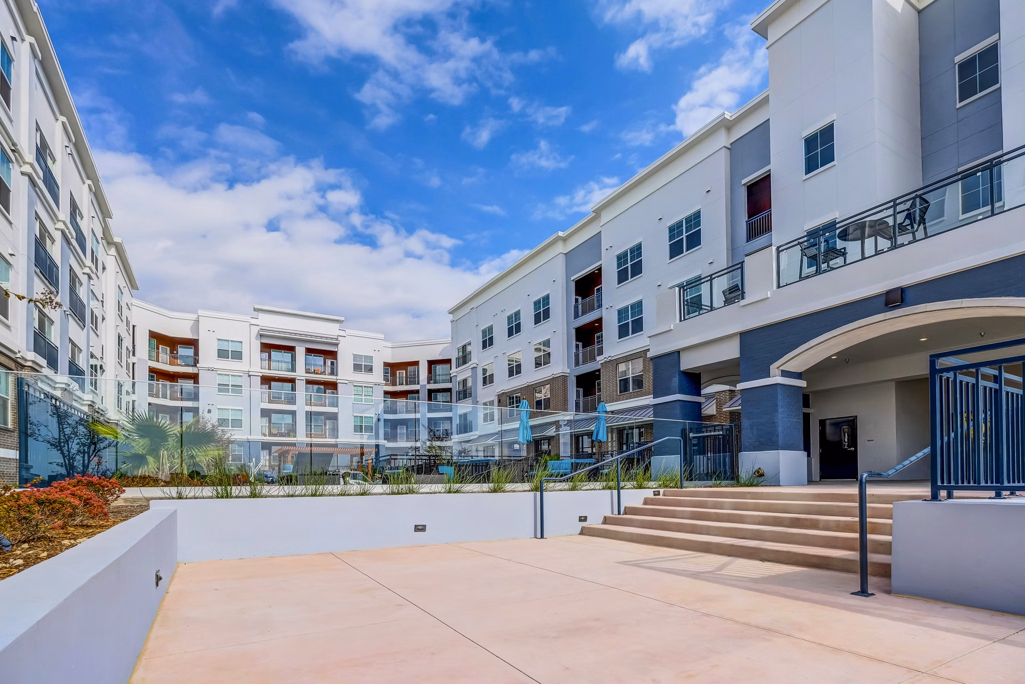 Pool patio with lounge chairs and umbrellas at Shoreview Flats Apartments, showcasing a luxury outdoor amenity for residents