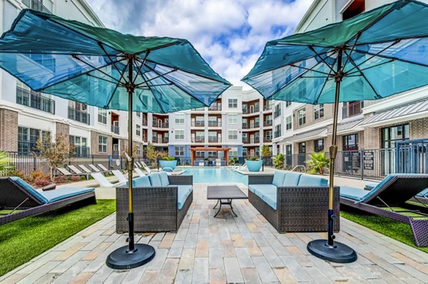 Luxurious outdoor pool with lounge chairs at Shoreview Flats Apartments offering relaxation and leisure amenities for residents