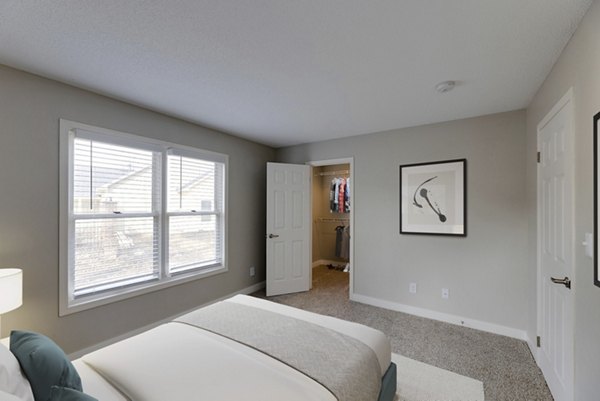 Bedroom featuring cozy king-size bed and elegant decor at Wellington Apartments