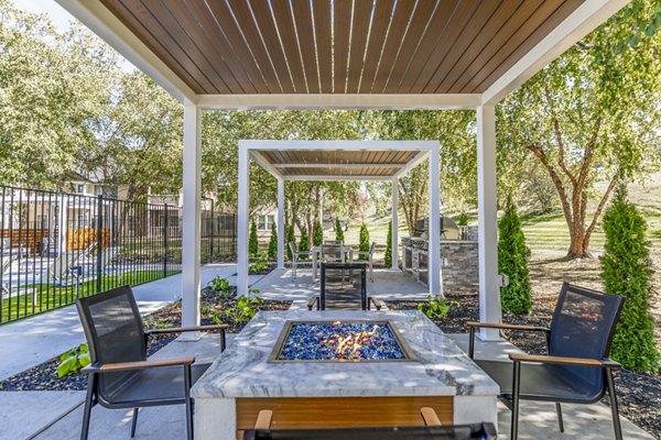 Cozy fire pit on a modern patio at Wellington Apartments