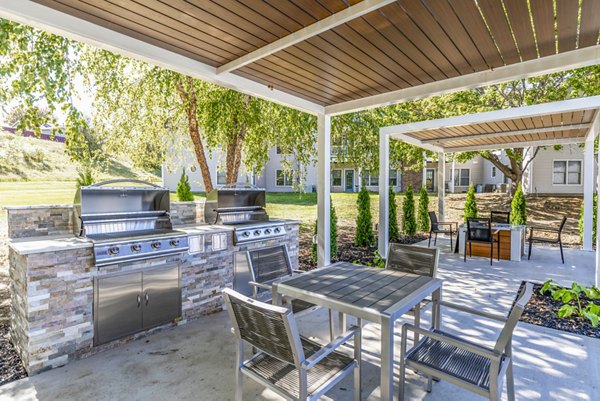 Outdoor grill area and patio at Wellington Apartments, ideal for gatherings and leisure, at Greystar's upscale living community