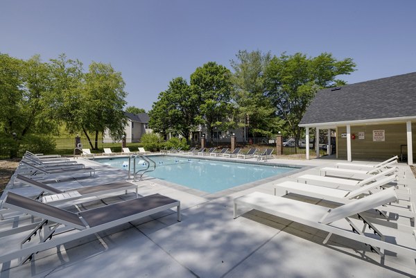 â€œResort-style pool area with poolside lounge chairs at Wellington Apartmentsâ€