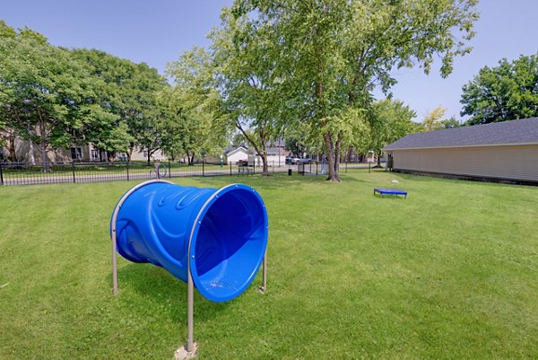 Dog-friendly park with walking paths at Wellington Apartments, perfect for pet owners seeking outdoor space in a luxury community