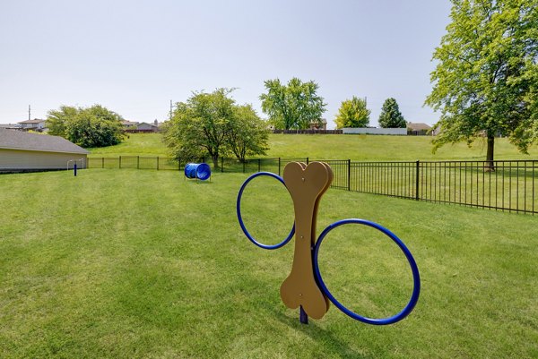 Dog park with agility equipment at Wellington Apartments