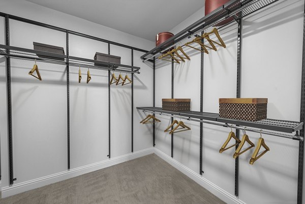 Walk-in closet with ample shelving and storage at Novel Turtle Creek Apartments
