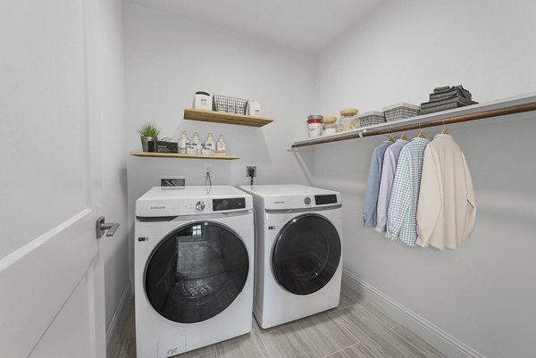Laundry room featuring modern appliances at Novel Turtle Creek Apartments