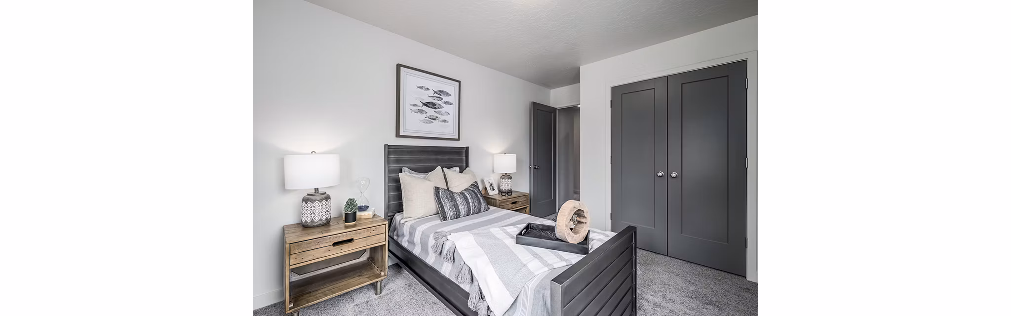 Modern bedroom with cozy bedding and city views at Banner Hill Apartments
