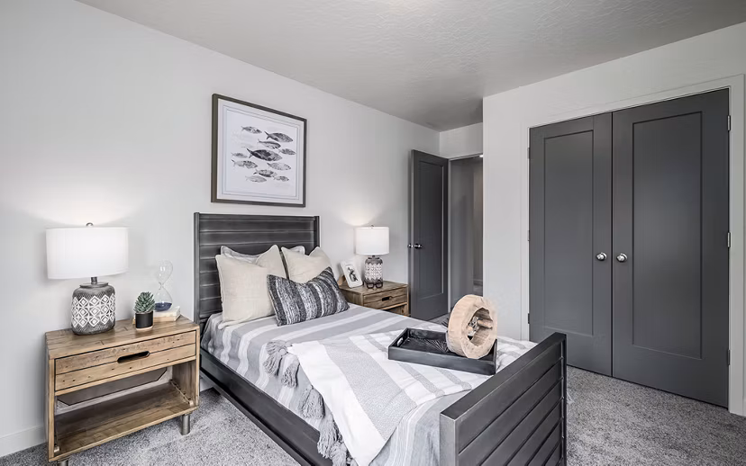 Modern bedroom with cozy bedding and city views at Banner Hill Apartments