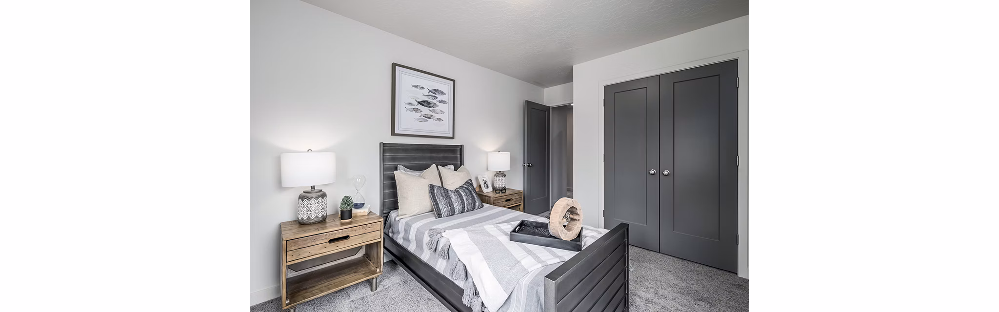 Modern bedroom with cozy bedding and city views at Banner Hill Apartments
