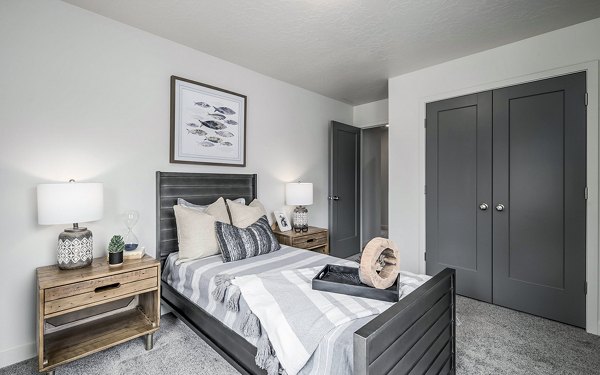 Modern bedroom with cozy bedding and city views at Banner Hill Apartments