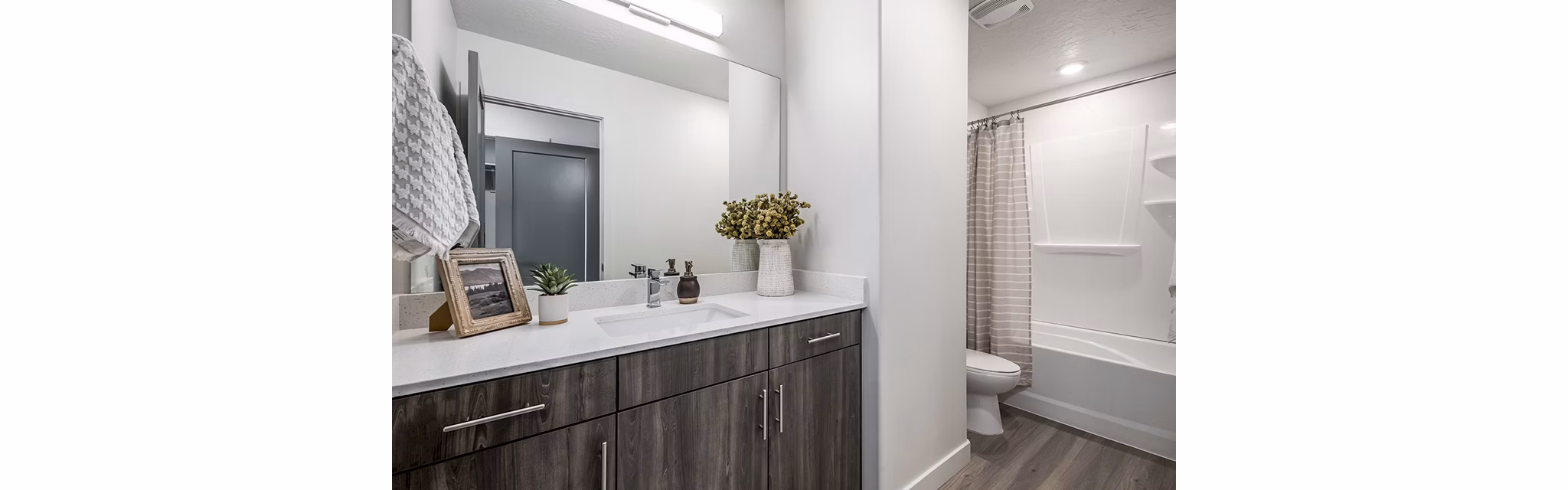Banner Hill Apartments: Modern bathroom with sleek fixtures and marble countertop