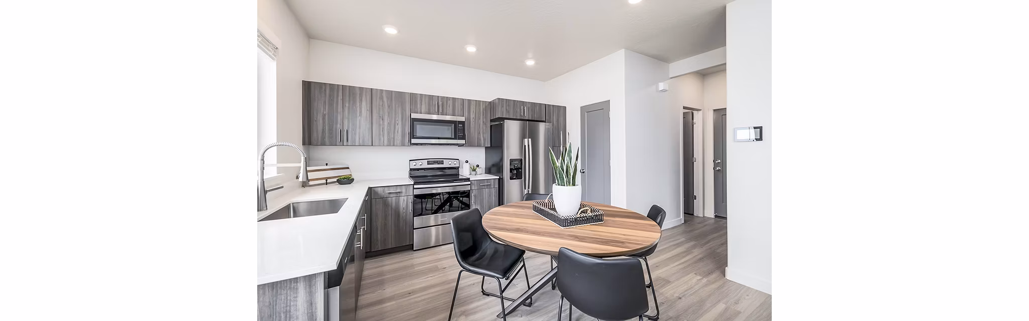 Dining room with modern decor and large windows at Banner Hill Apartments