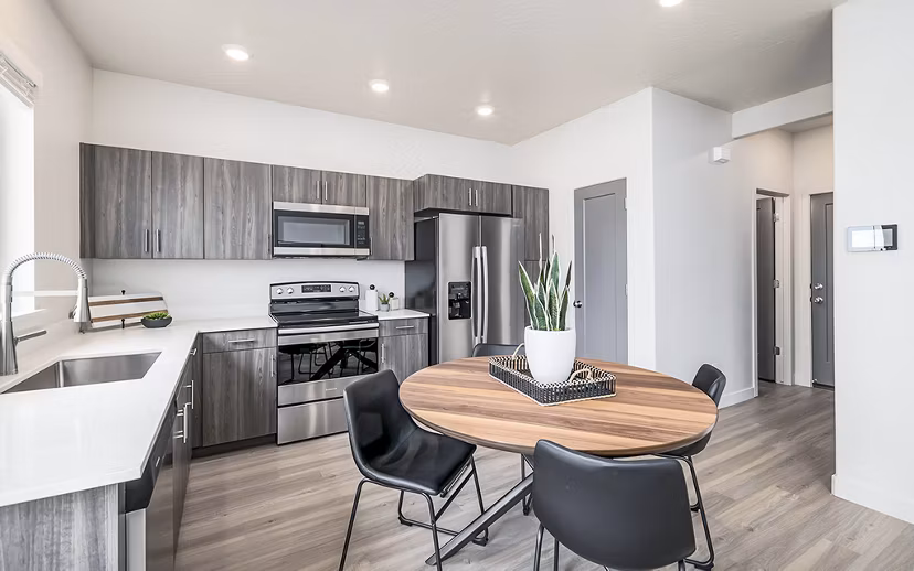 Dining room with modern decor and large windows at Banner Hill Apartments
