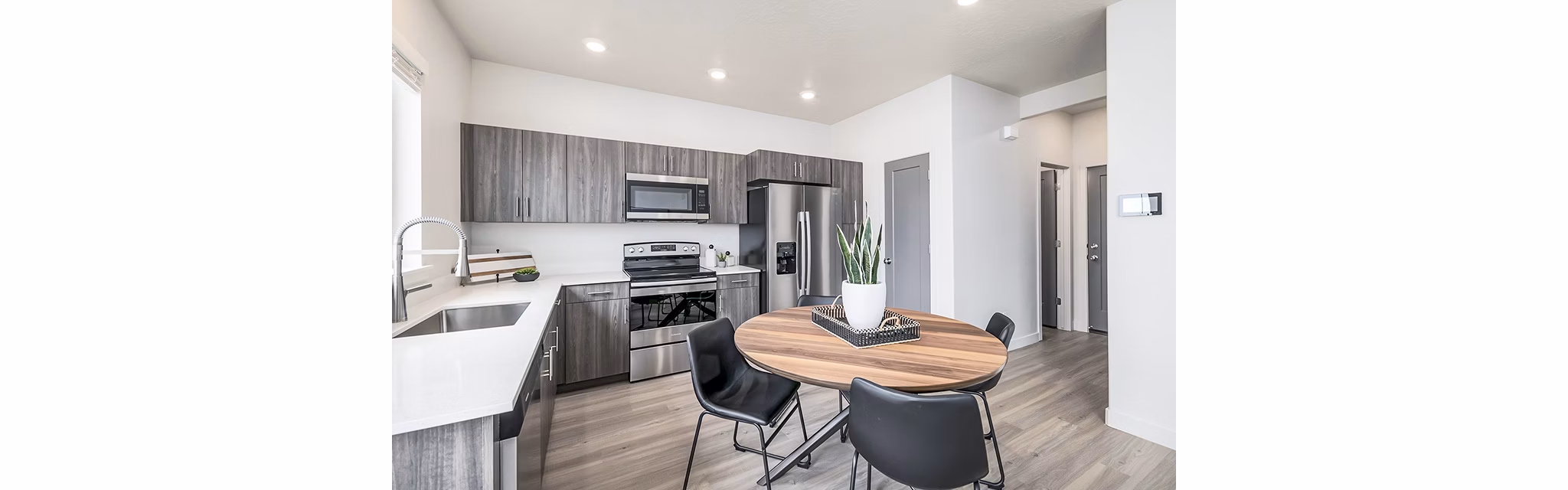 Dining room with modern decor and large windows at Banner Hill Apartments