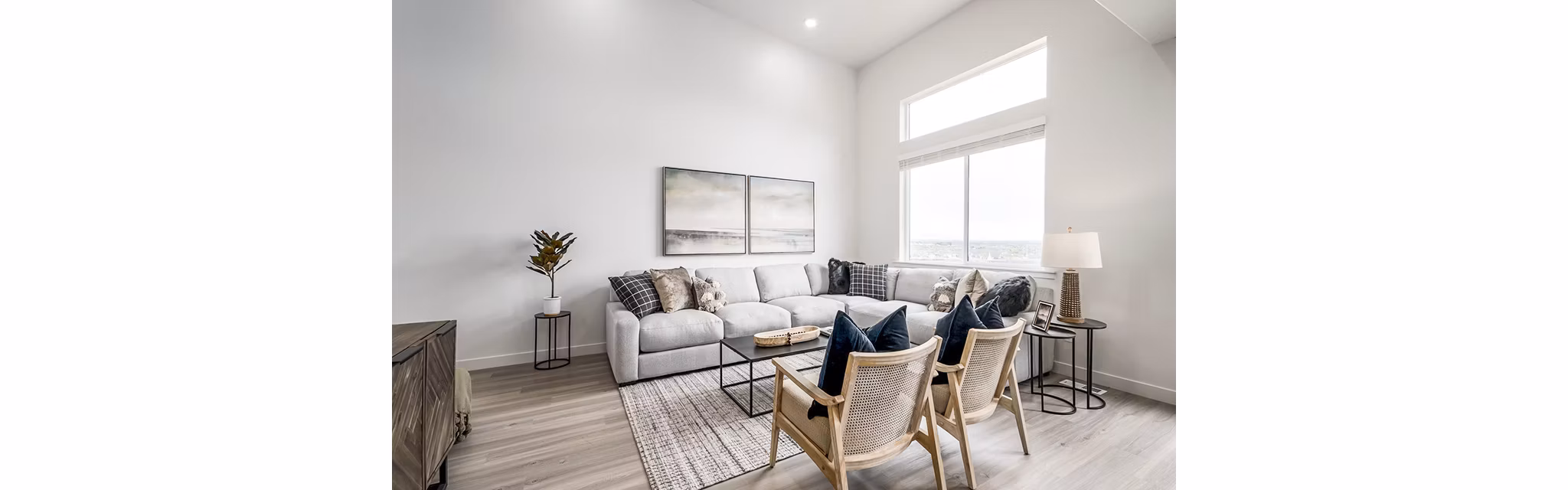 Modern living room with sleek furniture and large windows at Banner Hill Apartments