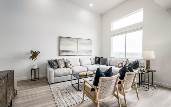 Modern living room with sleek furniture and large windows at Banner Hill Apartments