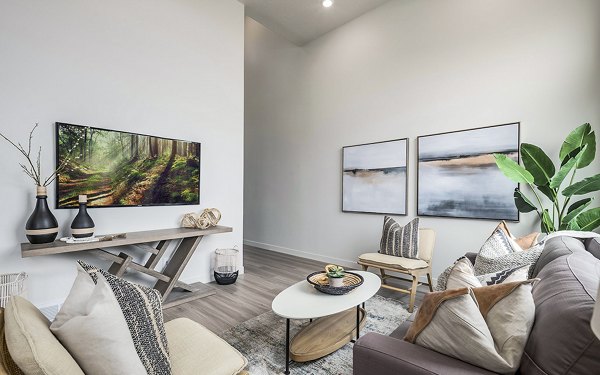 Contemporary living room with stylish decor at Banner Hill Apartments, featuring urban views and modern furnishings