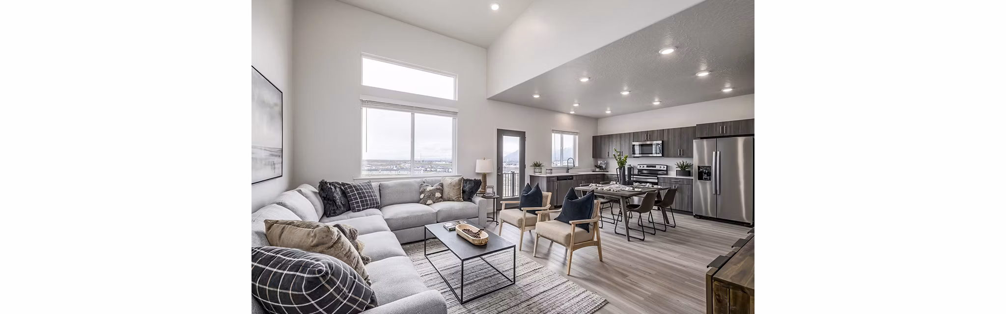 Elegant living room with modern decor and large windows at Banner Hill Apartments
