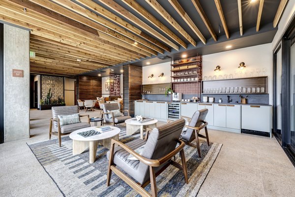 Clubhouse with lounge seating and flat-screen TV at Broadstone Vin Apartments