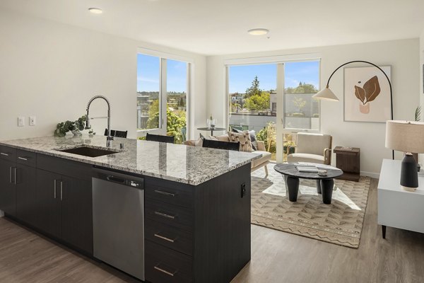 Modern kitchen with stainless steel appliances and granite countertops in Broadstone Vin Apartments