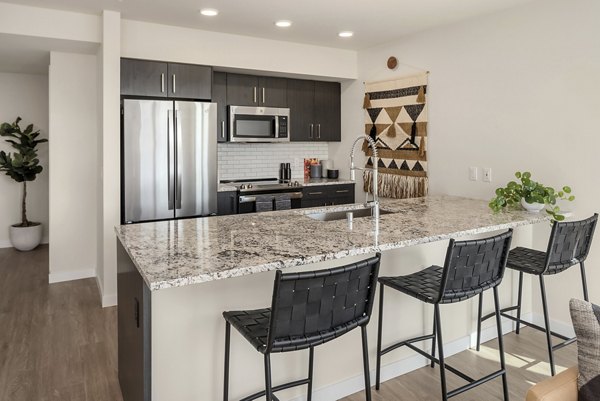 Modern kitchen featuring stainless steel appliances in Broadstone Vin Apartments