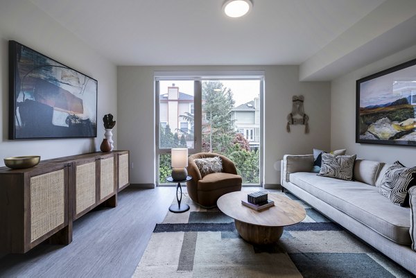 Stylish living room with modern decor and large windows in Broadstone Vin Apartments