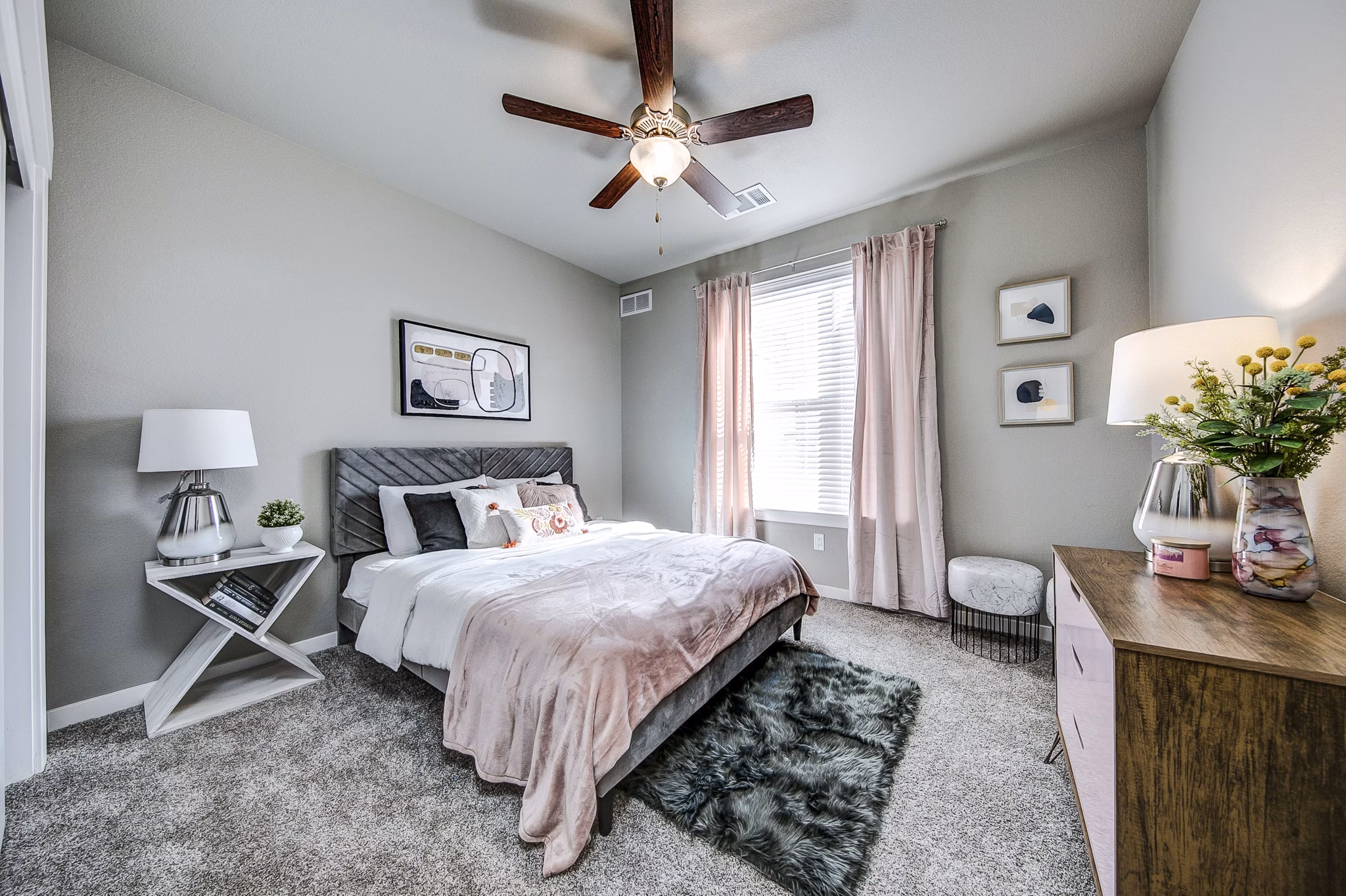 Cozy bedroom with large windows and modern decor at The Bend at Highland Meadows Apartments