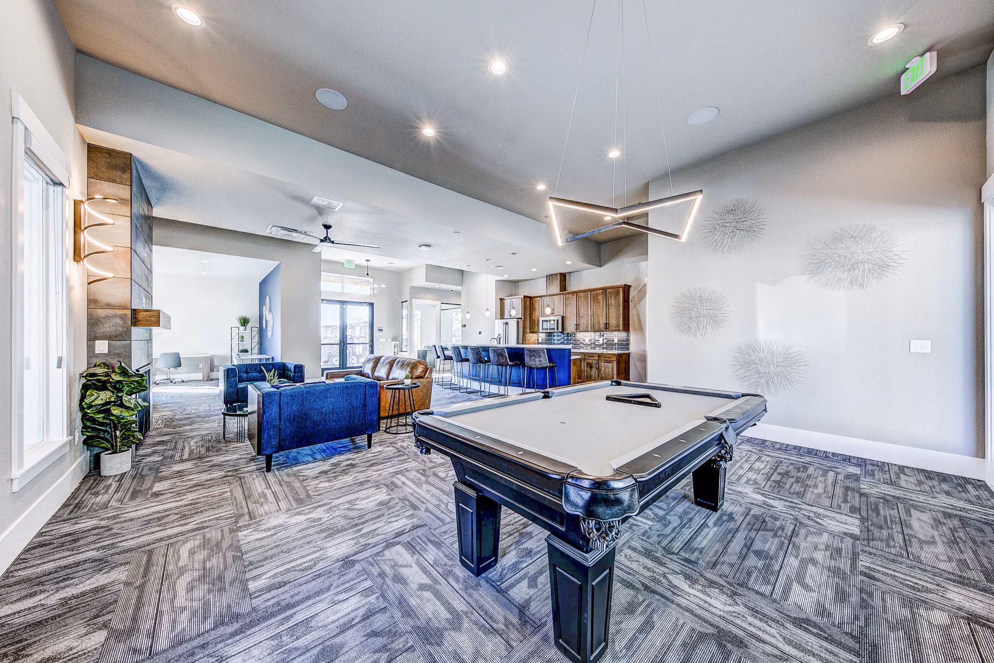 Clubhouse game room with pool table and seating area at The Bend at Highland Meadows Apartments