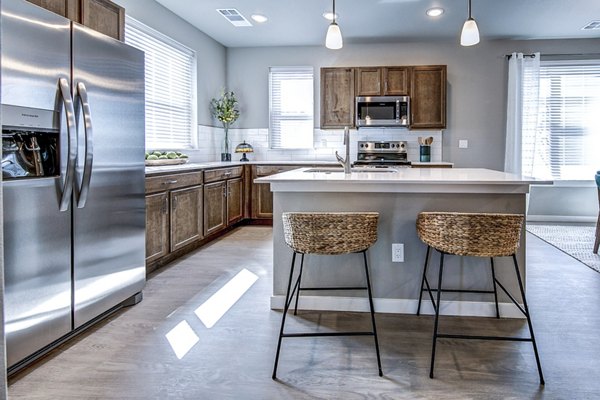 Modern kitchen with stainless steel appliances at The Bend at Highland Meadows Apartments