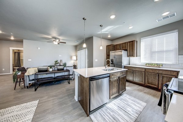 Modern kitchen with sleek countertops and stainless steel appliances at The Bend at Highland Meadows Apartments