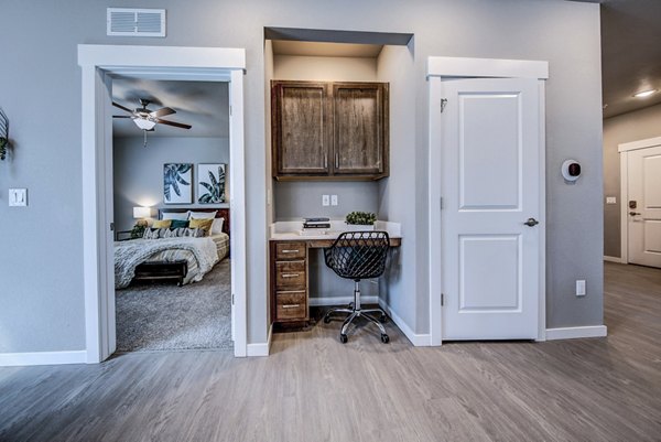 Home office area with modern furnishings in a living room at The Bend at Highland Meadows Apartments