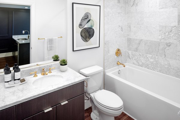 Elegant bathroom with marble countertops and modern fixtures at The Fitz Apartments