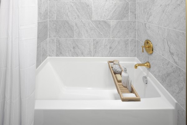 Modern bathroom featuring dual sinks and sleek fixtures at The Fitz Apartments