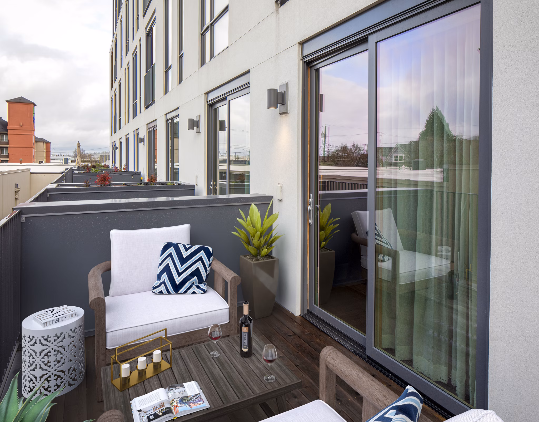 Patio with cozy seating and string lights at The Fitz Apartments, offering luxury outdoor relaxation in an upscale community setting